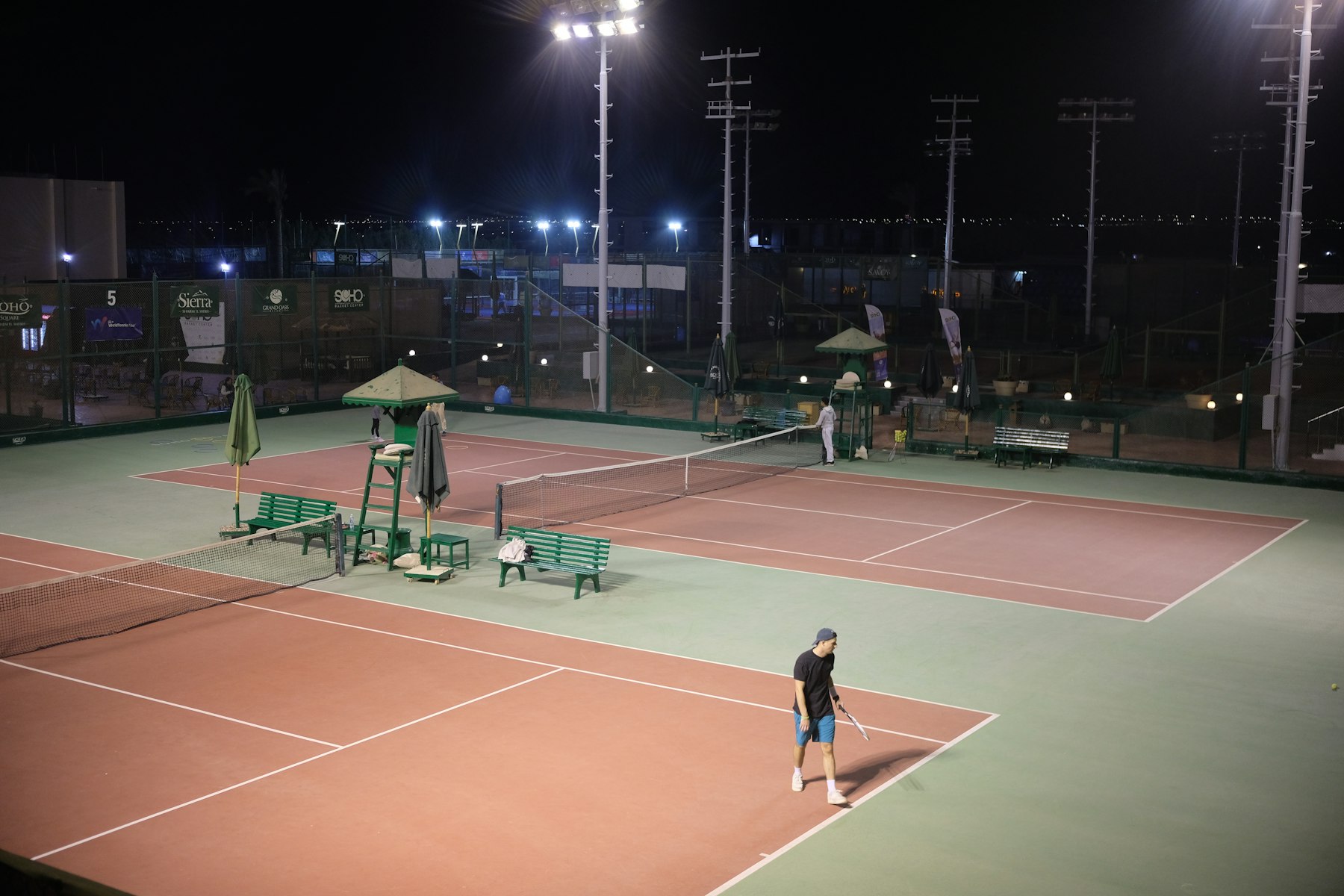 Tennis courts lit by LED floodlights at night
